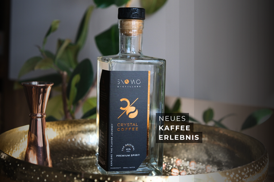 Flasche SNOWO Crystal Coffee Kaffeegeist auf goldenem Tablett mit Bar-Equipment – modernes Kaffee-Erlebnis als klares Destillat